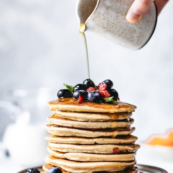 Almond Flour Pancakes Recipe being drizzled with maple syrup