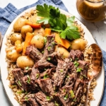 Instant Pot Pot Roast on a plate with potatoes and pilaf