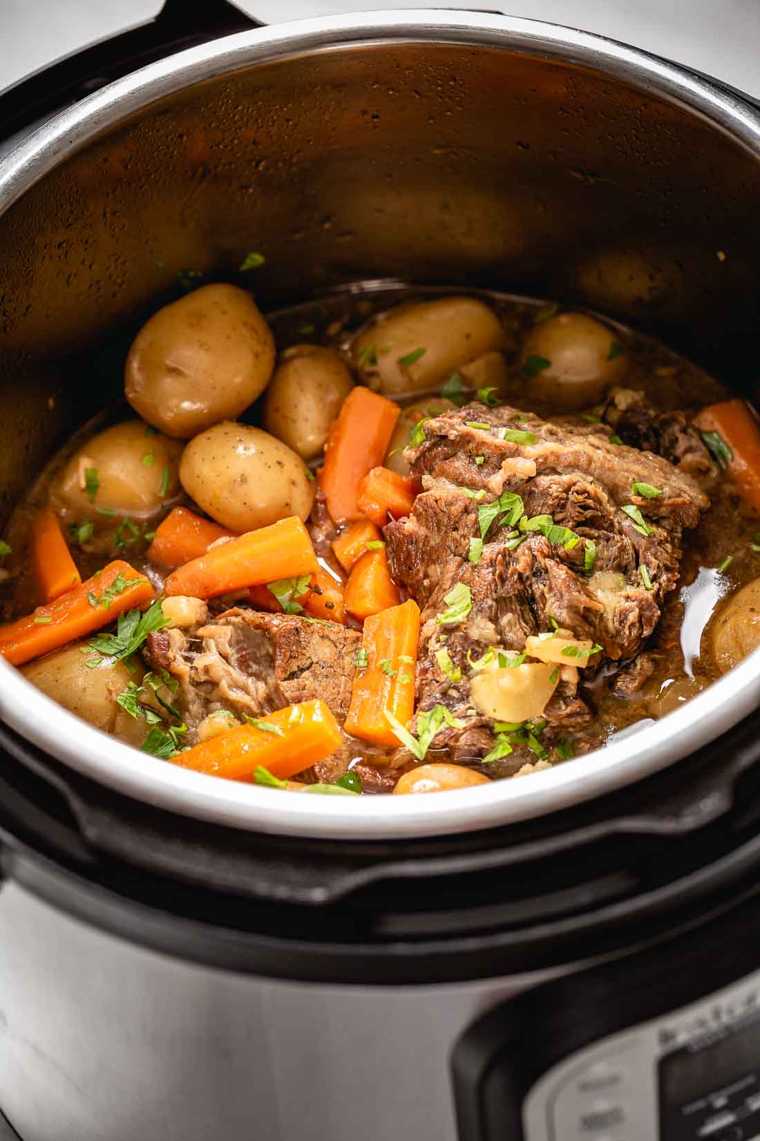 Pot Roast in Pressure cooker- Cooked meat dish is in the instant pot
